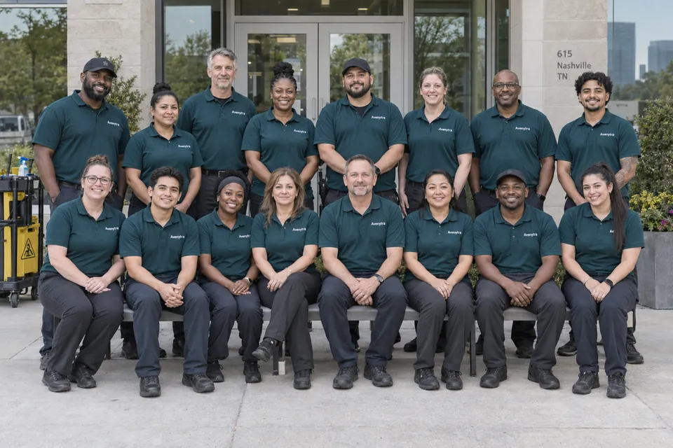 AI-generated illustrative portrait of 16 cleaning crew members wearing teal Avenytra uniforms